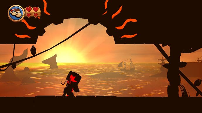 A silhouette of Donkey Kong carrying a barrel on his back as he travels through a sunset beach level in Donkey Kong Country Returns HD.