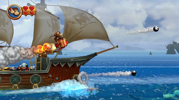 Donkey Kong flies on a rocket powered barrel to avoid cannonballs from a nearby galleon in Donkey Kong Country Returns HD.