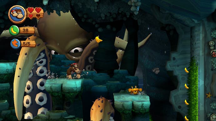 Donkey Kong avoids a large kraken tentacle in a sea cave level in Donkey Kong Country Returns HD.