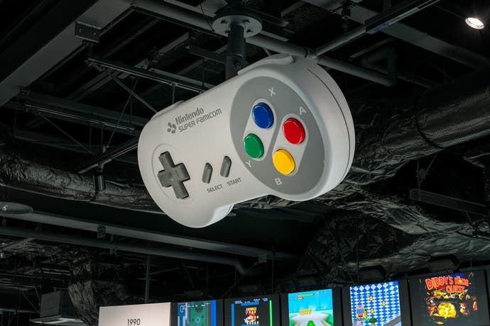 A giant SNES controller, suspended from the ceiling of the Nintendo Museum.