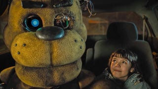 Five Nights at Freddy's film screenshot showing golden Freddy in a car