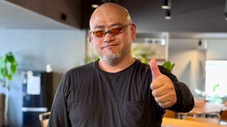 Photo of Hideki Kamiya in sunglasses holding his thumb up