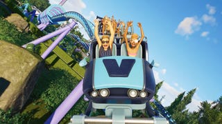 Planet Coaster 2 trailer screenshot showing characters riding a rollercoaster towards the camera with arms aloft