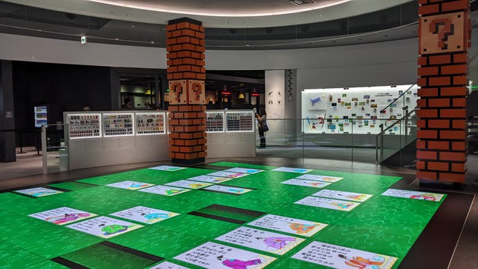 The interactive Hanafuda floor in the Nintendo Museum, which is surrounded by four brick pillars with Question Blocks in them.