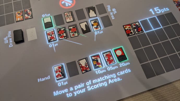 A top down photograph of a game of Hanafuda cards in the Nintendo Museum.